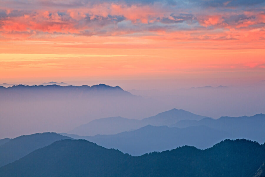 Pink dawn sky over the blue Himalayas mountains